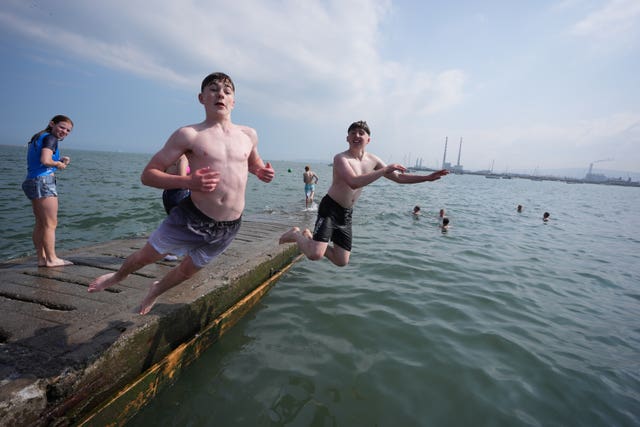 Owen Kelly, left, 16, and Niall McGrath, 15, cool off diving into the slip at Clontarf 
