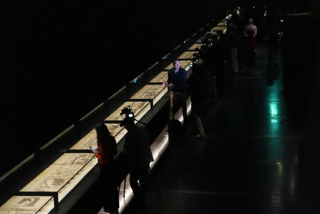 People attend a preview of the Bayeux Tapestry Exhibition at the British Museum in London