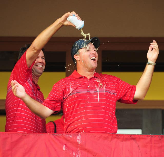 USA captain Paul Azinger pours a drink over Boo Weekley