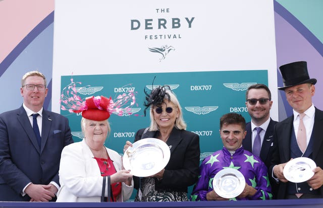 Jockey Andrea Atzeni (third right), Trainer George Boughey (right) and winning connections celebrate after Navello won The Aston Martin “Dash” Handicap 