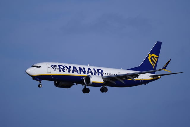 View of a Ryanair plane in the air, surrounded by blue sky