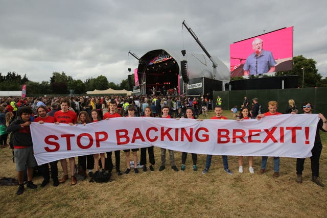EU supporters hold up an anti-Brexit banner while Jeremy Corbyn delivers a speech