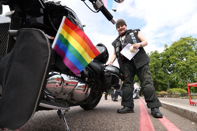 Valkyrie from Gloucester attaches Pride decorations to a motorbike