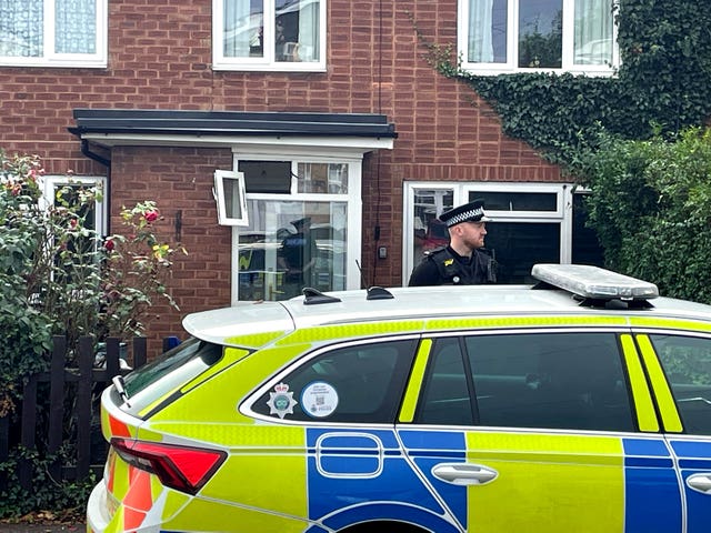 A police officer outside a property in Main Street, Stonnall (Matthew Cooper/PA)