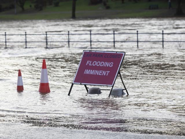 A flood warning sign at the entrance to a flooded car park in Whitesands, Dumfries