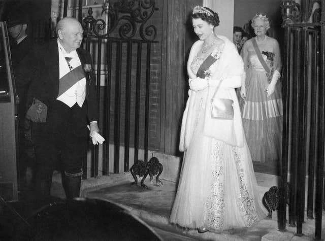 Sir Winston Churchill opens the door of the Queen's car