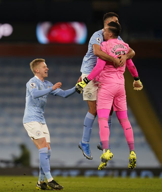 Manchester City goalkeeper Ederson (right) is congratulated by team-mates Joao Cancelo (centre) and Oleksandr Zinchenko after setting up Ilkay Gundogan to score