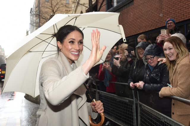 The rain did not dampen Meghan's spirits (Joe Giddens/PA)