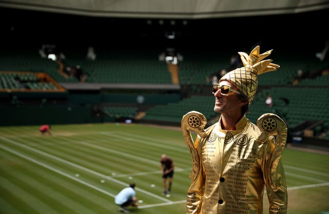 Fan Chris Fava, dressed as the men's singles trophy, made a Centre Court appearance on Monday