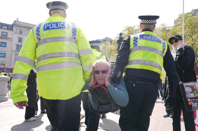Police remove a protester at a demonstration against the ban on Palestine Action, in Trafalgar Square central London