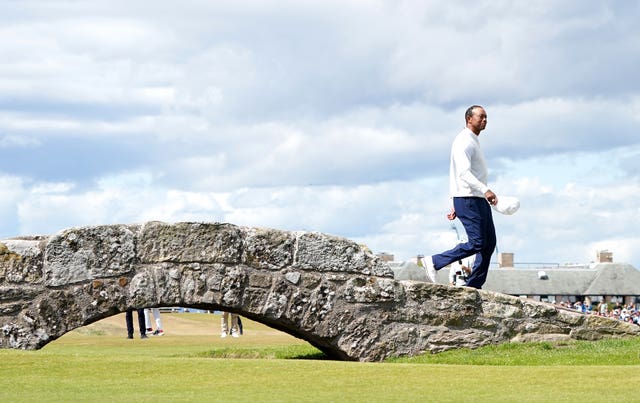 Tiger Woods crosses the Swilcan Bridge at St Andrews