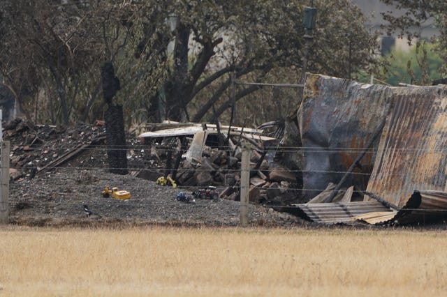 The scene showing a burnt out car after a blaze in the village of Wennington, east London