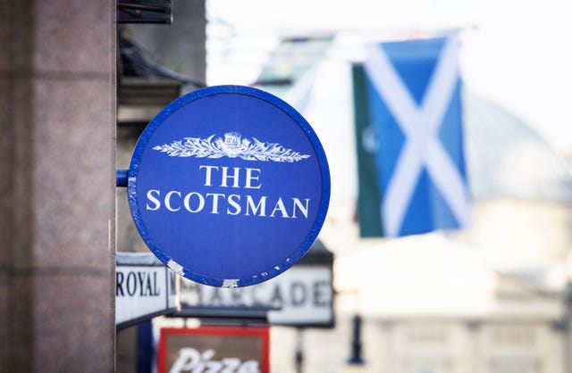 A round sign for The Scotsman