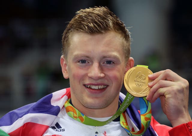 Adam Peaty with his 2018 Olympic gold medal in the 100m breaststroke