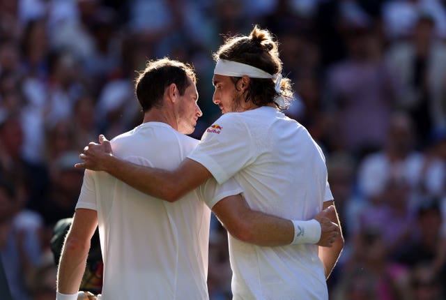 Andy Murray, left, and Stefanos Tsitsipas embrace