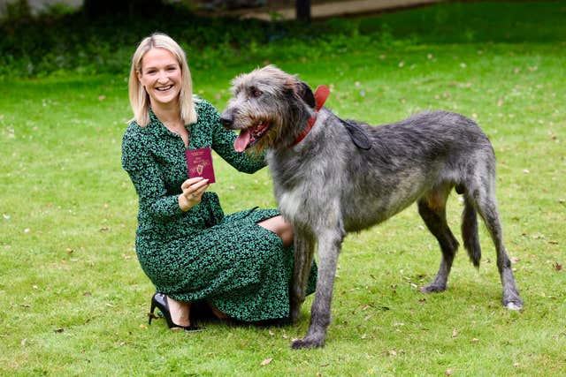 Minister Helen McEntee with Oisin the wolfhound and a new passport