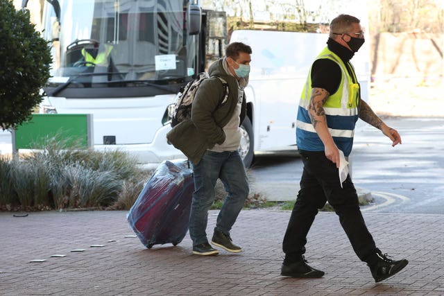 A passenger is escorted to the Holiday Inn hotel near Heathrow Airport