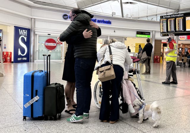 Amelia Reid and her partner Samuel Sharp welcomed back at Heathrow