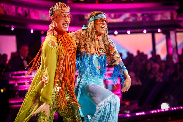 Karen Carney and Carlos Gu dressed as hippies while performing on Strictly