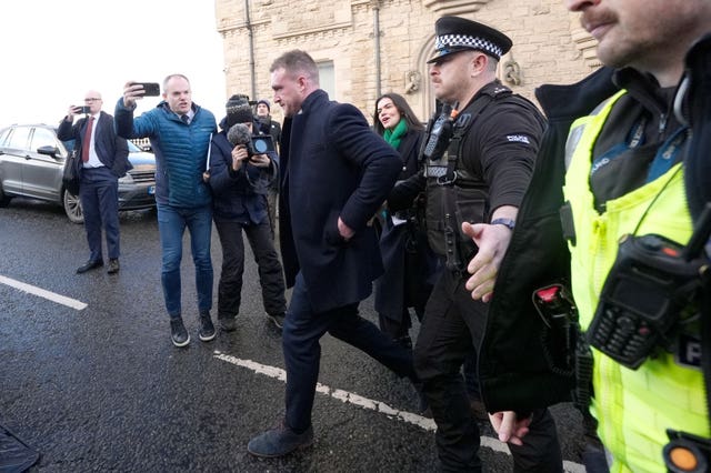 Stuart Hogg surrounded by police and media outside court