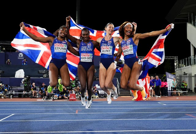 Success Eduan, Dina Asher-Smith, Amy Hunt, and Imani-Lara Lansiquot, left to right, jump in celebration after winning the women's 4x100m