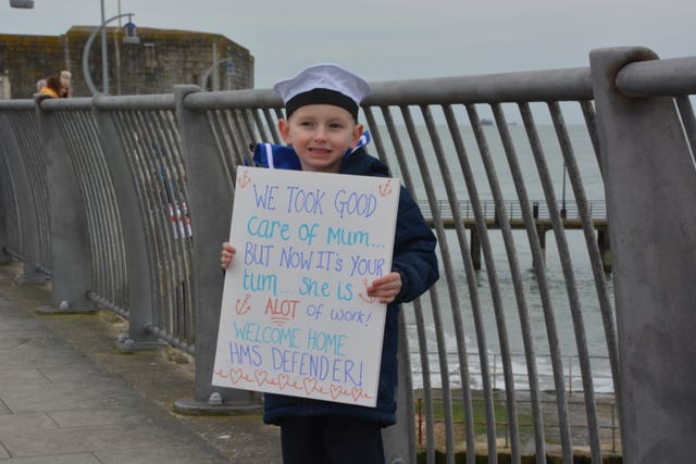 Six-year-old Oscar gets ready to welcome his father home