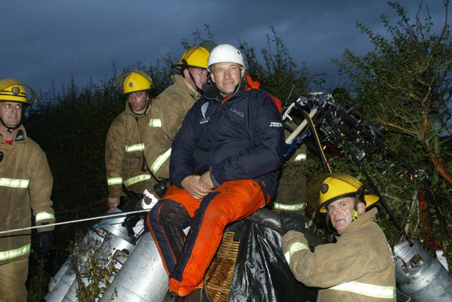 British adventurer David Hempleman-Adams on top of his balloon’s basket after landing safely in Britain after becoming the first person to cross the Atlantic solo in an open wicker basket balloon in 2003