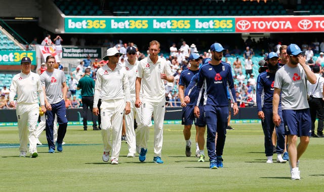 England’s players look dejected after defeat during day five of the Ashes Test match at Sydney (Jason O'Brien/PA)