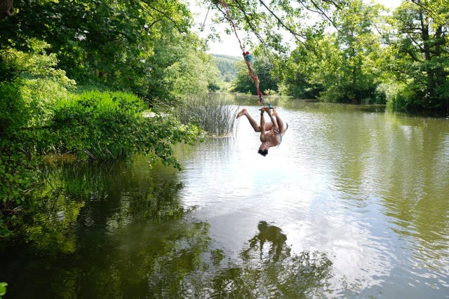 People swimming in a river at the end of May