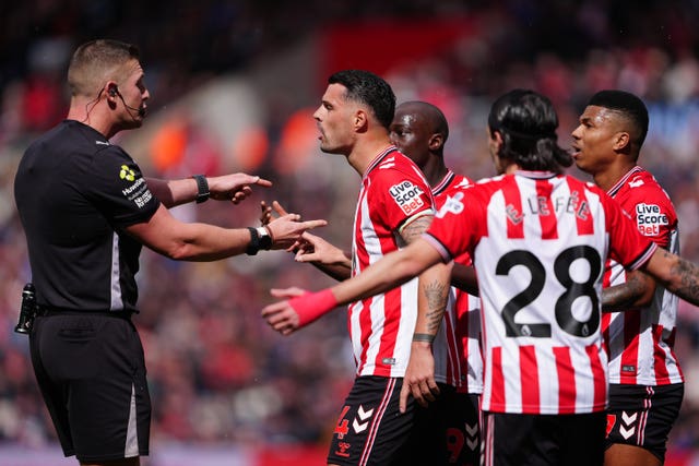 Sunderland’s Granit Xhaka (second left) speaks with referee Robert Jones after he awarded a penalty, but VAR intervened and disallowed the spot kick 