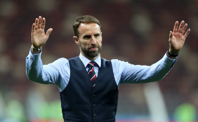 Gareth Southgate, wearing a waistcoat, acknowledges England's fans at the 2018 World Cup