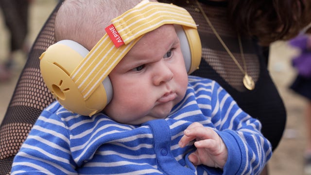 Baby wearing ear defenders