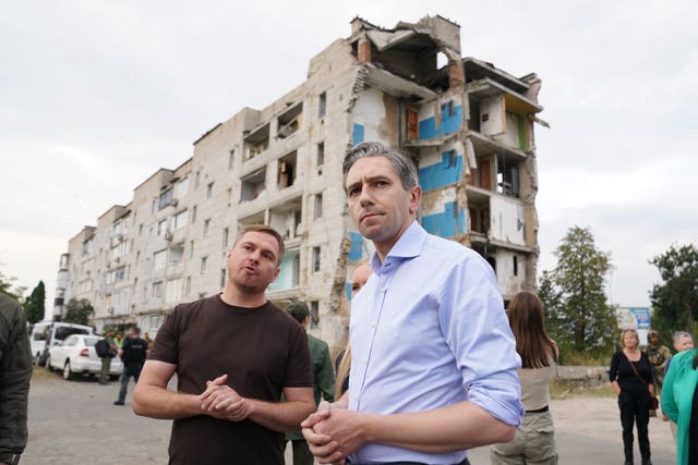 Taoiseach Simon Harris speaks to head of the Kyiv state regional administration, Ruslan Kravchenko, during a visit to inspect damage to buildings in Borodyanka 