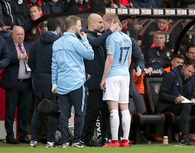 Manchester City manager Pep Guardiola consoles the injured Kevin De Bruyne 