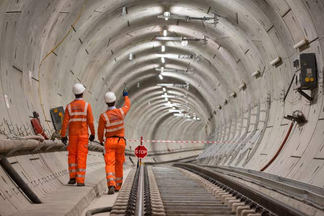 Crossrail engineers walking alongside completed tracks