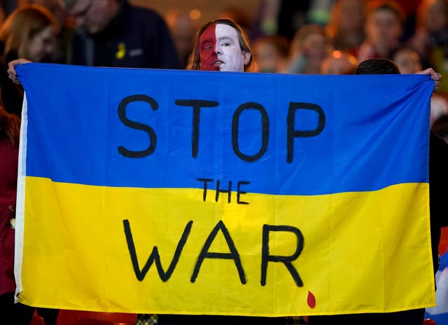 A man holds up a flag in support of Ukraine