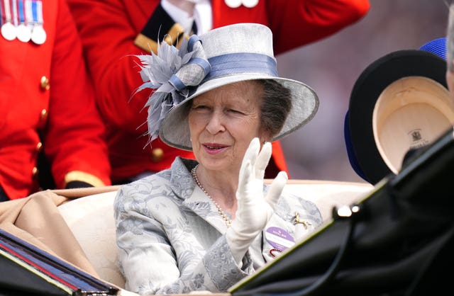 Princess Anne in a silver hat in a carriage