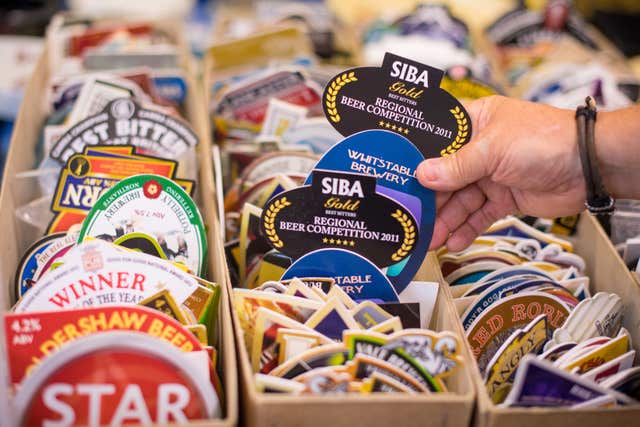 A visitor browses beer mats on sale