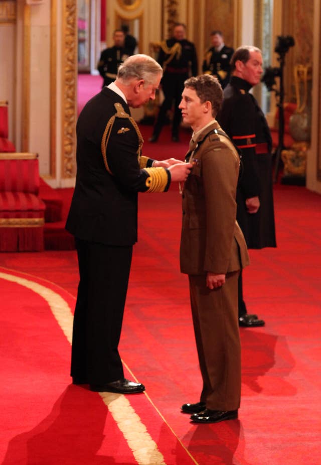Mr Cutterham is presented with the Conspicuous Gallantry Cross by Prince Charles during an investiture ceremony at Buckingham Palace in 2012 (Lewis Whyld/PA).