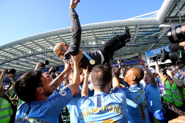 Pep Guardiola celebrates with his players