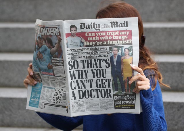 Someone reading a copy of the Daily Mail