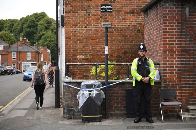 A police officer by a sealed off litter bin in Rollestone Street, Salisbury, Wiltshire 