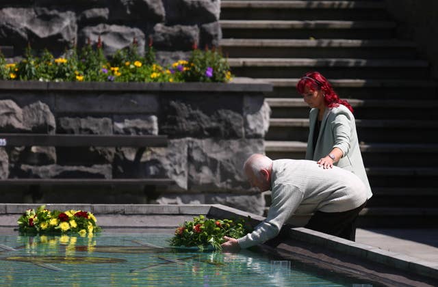 Family members lay wreaths during a Stardust ceremony of commemoration at the Garden of Remembrance in Dublin