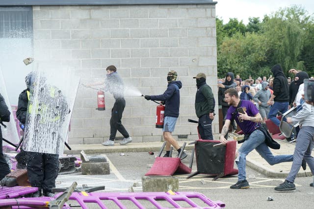 Levi Fishlock (right) during an anti-immigration demonstration outside the Holiday Inn Express in Rotherham