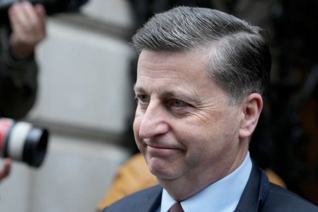 Side view headshot of Douglas Alexander smiling