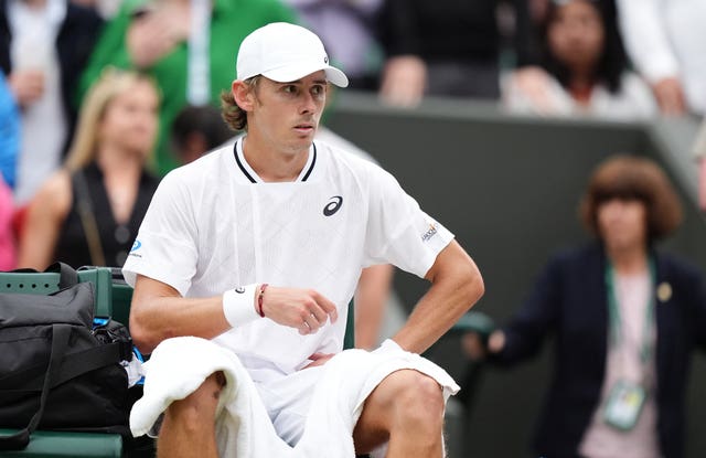 Alex de Minaur clutches his hip after victory over Arthur Fils at Wimbledon in 2024