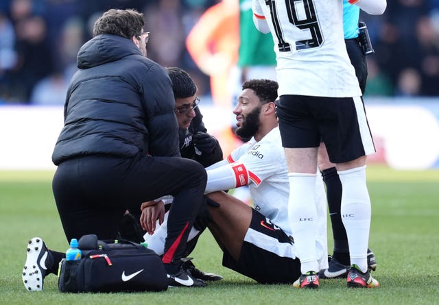 Liverpool defender receives treatment for an injury