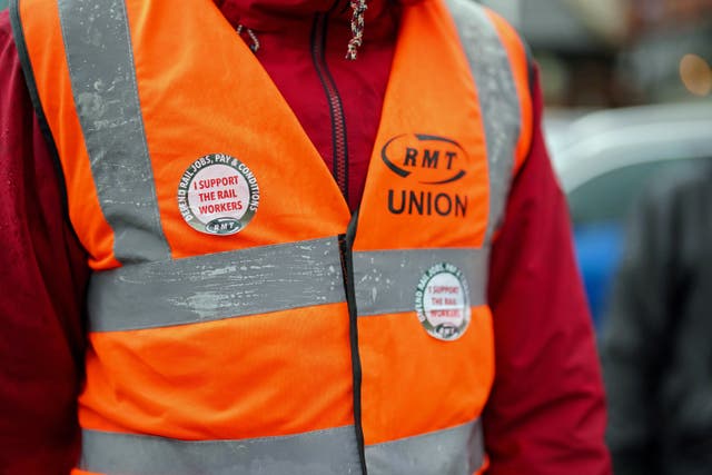 A member of the Rail, Maritime and Transport union on the picket line 