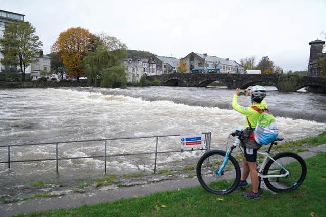 The River Kent was surging in Kendal (Owen Humphreys/PA)