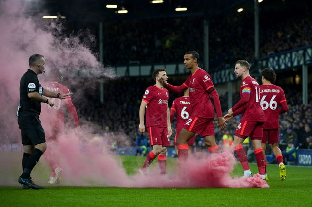 A smoke flare lands on the pitch at Everton